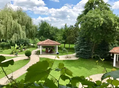 a gazebo in the middle of a park at Yaev Family Hotel in Karlovo