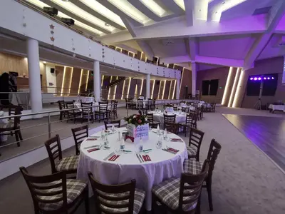 a banquet hall with white tables and chairs and purple lighting at Wine & Spa Complex Starosel in Starosel