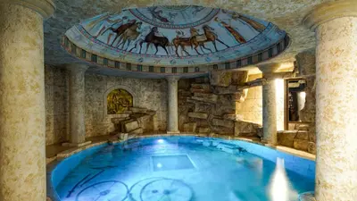 a large swimming pool in a building with a ceiling at Wine & Spa Complex Starosel in Starosel