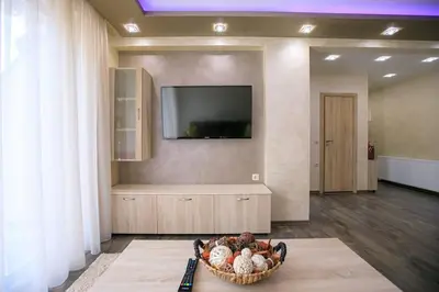 a living room with a television and a basket of balls at Апартамент Радост Сандански in Sandanski