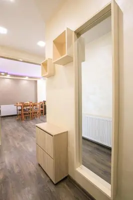 a room with a large window and a table with chairs at Апартамент Радост Сандански in Sandanski