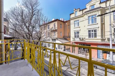 a yellow balcony with a view of a street at Chic 1BR with Terrace in Sofia City Center by Flat Mаnager in Sofia