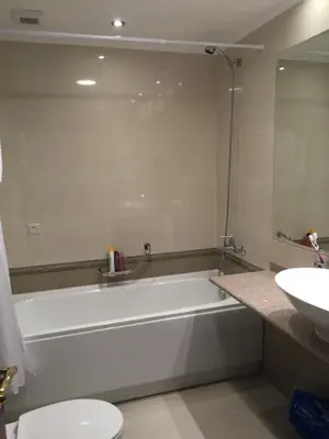 a bathroom with a bath tub and a sink at Downtown Alexander Services Apartments in Bansko