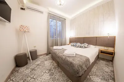 a hotel room with a bed and a window at Sofia Pearl Life Apartment - No Window Apartment in Sofia