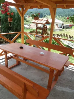 a wooden picnic table in a gazebo at вила Здравец in Yagodina
