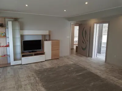 a living room with a flat screen tv sitting on a entertainment center at United Apartments 2 in Sandanski