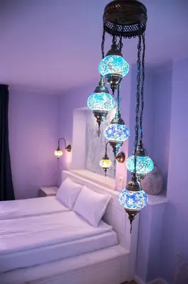 a bedroom with blue lights hanging from a chandelier at SABORNA 25 GUEST HOUSE in Plovdiv