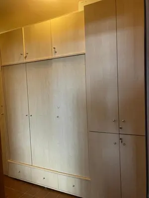 a bunch of cabinets in a room with a wall at Cedar Lodge 3/4 Apartment Paradise in Bansko