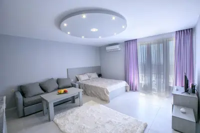 a living room with a couch and a bed at Студиа КРИСИ in Sandanski