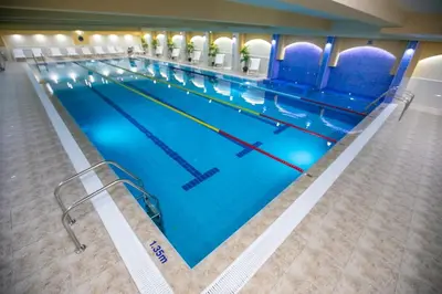 a large swimming pool in a hotel room at Студиа КРИСИ in Sandanski