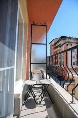 a balcony with two chairs and a table on it at Студиа КРИСИ in Sandanski