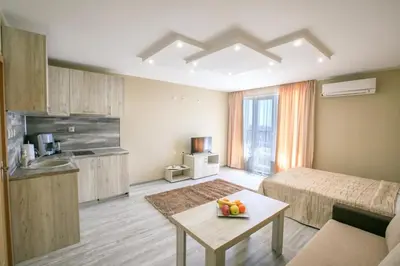 a room with a bed and a table with fruit on it at Студиа КРИСИ in Sandanski
