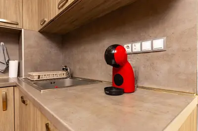 a red object is sitting on a kitchen counter at GLORIOUS - 2-Bedroom apartment near Youth Hill by Flat Mаnager in Plovdiv