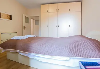 a bedroom with a large bed with white cabinets at GLORIOUS - 2-Bedroom apartment near Youth Hill by Flat Mаnager in Plovdiv