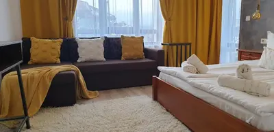 a living room with a couch and a couch and a bed at Ice Jewel Chalet, Bansko, 200 meters from the Gondola, 20 улица „Свети Иван Рилски“ in Bansko