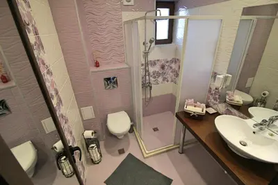 a bathroom with a shower and a toilet and a sink at Ice Jewel Chalet, Bansko, 200 meters from the Gondola, 20 улица „Свети Иван Рилски“ in Bansko