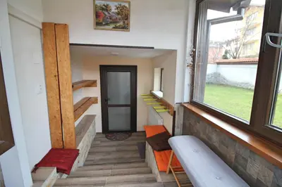 a hallway with stairs leading to a door and a window at Ice Jewel Chalet, Bansko, 200 meters from the Gondola, 20 улица „Свети Иван Рилски“ in Bansko