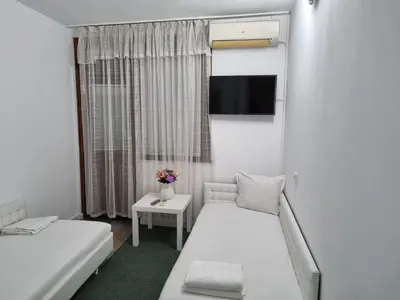 a small room with two beds and a tv at Motel Thessaloniki in Sandanski