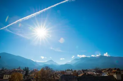 a sun in the sky over a city at Pri Ani Guest House in Bansko