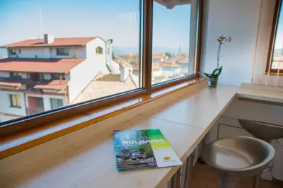 a book sitting on a desk in front of a window at Pri Ani Guest House in Bansko