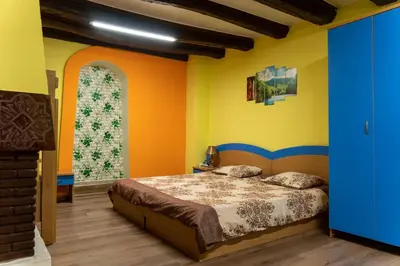 a bedroom with a bed and a large window at Апартамент 