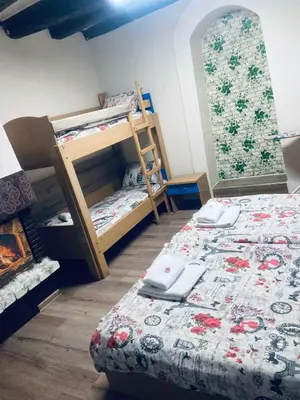 a bedroom with two bunk beds and a fireplace at Апартамент 