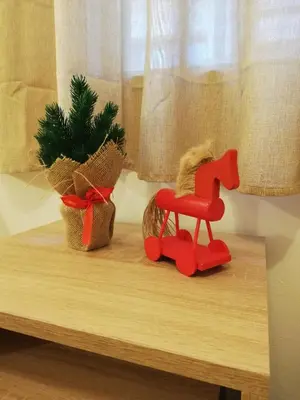 a toy horse and a plant on a table at Къща за гости Romano in Chepelare