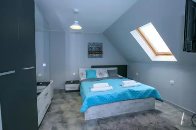 a bedroom with a bed with two towels on it at Sunpark Studios in Sandanski