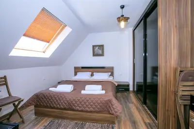 a bedroom with a bed with two pillows and a window at Sunpark Studios in Sandanski