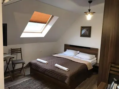 a bedroom with a bed with two pillows and a window at Sunpark Studios in Sandanski