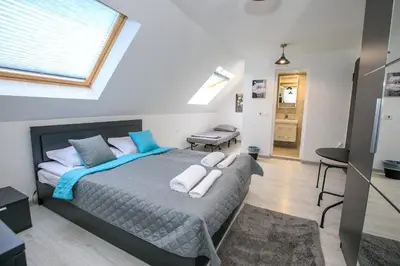 a bedroom with a bed with towels on it at Sunpark Studios in Sandanski