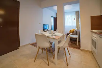 a kitchen and dining room with a table and chairs at Comfort.Chic.Charming Apt with Terrace near NDK in Sofia
