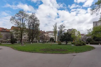 a park with a circle of grass and buildings at Comfort.Chic.Charming Apt with Terrace near NDK in Sofia