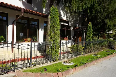 a fence in front of a house with plants at Complex Praveshki Hanove in Pravets