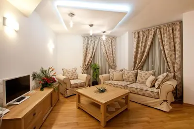 a living room with a couch and a tv at Earth & People Hotel & SPA - Free Parking & Swimming Pool in Sofia