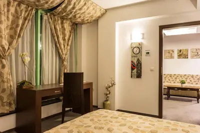 a bedroom with a desk and a window at Earth & People Hotel & SPA - Free Parking & Swimming Pool in Sofia