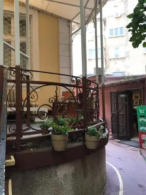 a balcony with potted plants on the side of a building at Come inn - 24h Self Check-in in Sofia
