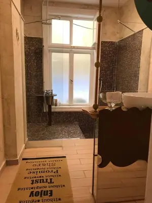 a bathroom with a shower with a window and a sink at Come inn - 24h Self Check-in in Sofia