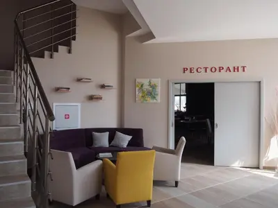 a living room with a purple couch and yellow chairs at A-Apartment in Krasnovo