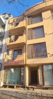 a tall building with windows on the side of it at Апартамент Мегилукс in Blagoevgrad