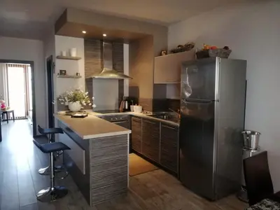 a kitchen with a stainless steel refrigerator and a counter at Апартамент Мегилукс in Blagoevgrad