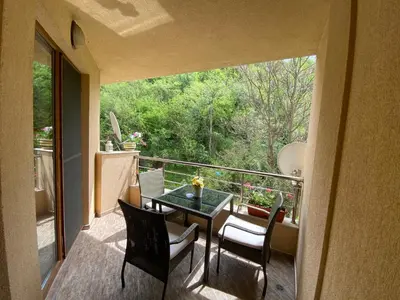 a view of a balcony with a table and chairs at Апартамент Мегилукс in Blagoevgrad