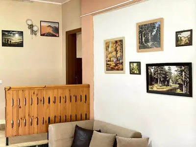 a living room with a couch and pictures on the wall at Vila Katerina in Yundola