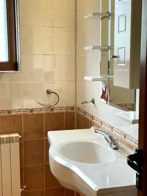 a bathroom with a sink and a mirror at Vila Katerina in Yundola