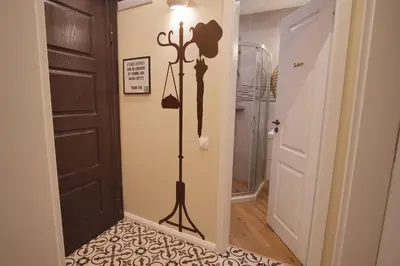 a hallway with a door with a tripod on the wall at Apartment Audrey by SofiaSpot - central, metro to airport in Sofia
