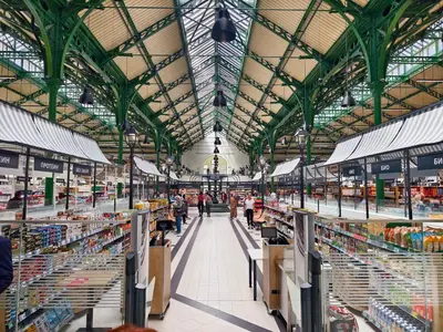 a large market with people walking through the aisle at Apartment Audrey by SofiaSpot - central, metro to airport in Sofia