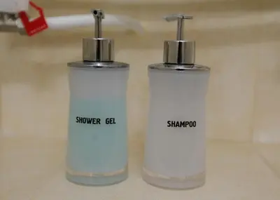 two bottles sitting next to each other on a counter at NIKI Apart in Sofia