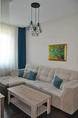 a living room with a couch and a table at Къща за гости Ирис in Kyustendil
