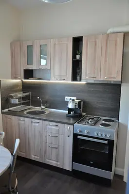 a kitchen with a stove and a sink at Къща за гости Ирис in Kyustendil