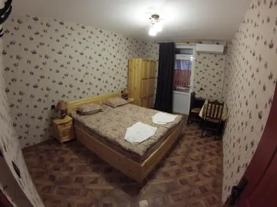 a small bedroom with a bed and a chair at Къща за гости с минерална вода 